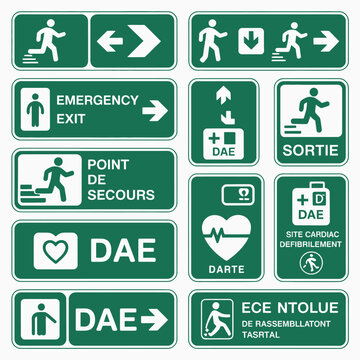 Collection of Green Emergency Exit and Defibrillator Location Signs Featuring Running Figures Arrows and Text in French and Other Languages