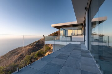 A grand hillside property a minimalist lookout platform with glass railings basalt flooring perched on a cliff edge