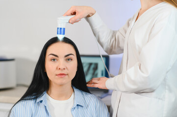 Doctor diagnoses the structure of the hair. Consultation with a trichologist