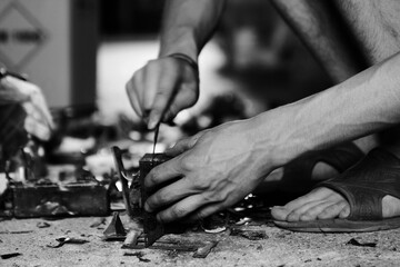 Close up of a man disassembling appliance