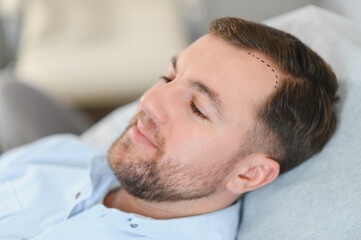 Side view of handsome man getting hair treatment at beauty salon. Man having mesotherapy session at...