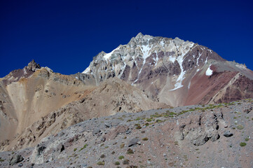 A sunny day in the Acancagua mountains. The steep cliffs, the foothills of the mountains are very hot from the sun and there is no vegetation