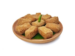 Tahu sumedang or Indonesian food made from deep-fried tofu on wooden plate. Isolated on white background 