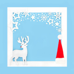 Obraz premium Christmas Eve reindeer, santa hat decoration, stars and snowflakes on blue background with white frame. Festive fantasy magical design.