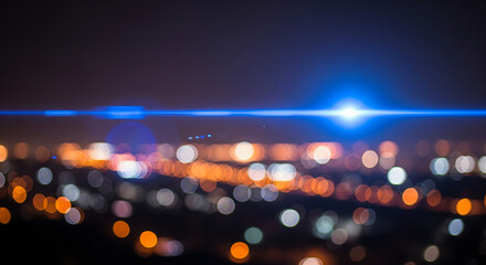 Abstract blue anamorphic lens flare overlaying blurry city night background, beautiful cinematic light effect with amazing colorful festive bokeh