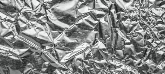 Shiny metal silver gray foil leaf crumpled texture background
