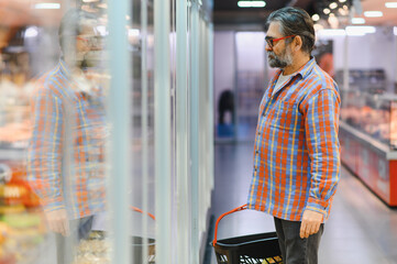 Senior man shopping for food at the supermarket