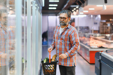 Senior man at grocery store products