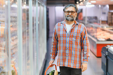 Senior man at grocery store products