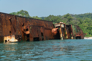 Wide shot of abandoned ship at the ocean of Pantai Pasir Putih or White Sand Beach in Pantai Barat...