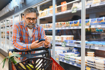Senior man at grocery store products