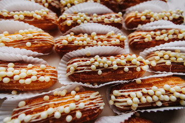 Eclair sprinkled with white chocolate, ideal dessert for a candy bar.