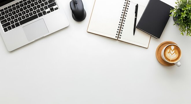 Minimalist Workspace: Laptop, Notebook, Coffee, and Plant on White Desk