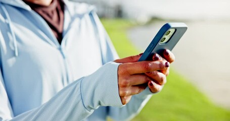Woman, hands and browsing with phone in nature for fitness, workout routine or schedule. Active, female person or research with mobile smartphone for exercise tips, health and wellness at lakeside