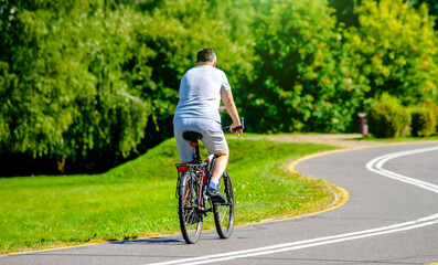 Cyclist ride on the bike path in the city Park
