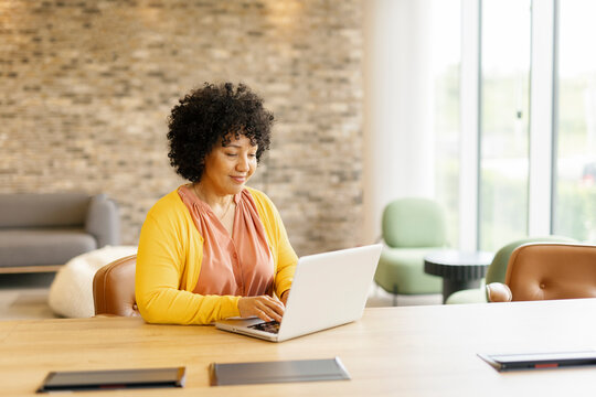 Entrepreneur working on a laptop in a modern office setting
