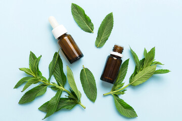 Natural Mint Essential Oil in a Glass Bottle. organic cosmetics with herbal extracts of mint on...