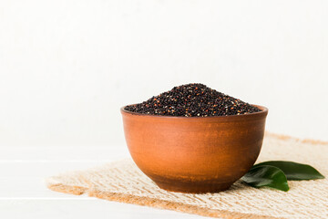 quinoa seeds in bowl on colored background. Healthy kinwa in small bowl. Healthy superfood