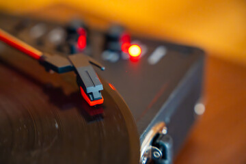 Close-up of record player needle tracking vinyl grooves during playback. Analog sound detail...