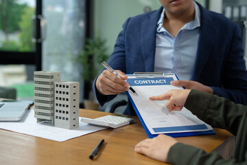 Real estate broker agent presenting and consult to customer to decision making sign insurance form...
