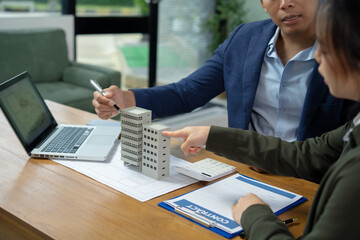 Real estate broker agent presenting and consult to customer to decision making sign insurance form...