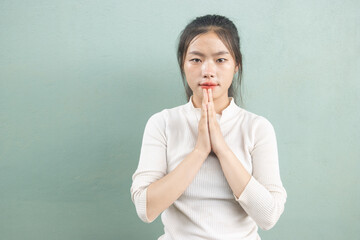 An Asian woman hands bowing or placing hands