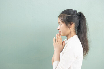 Side of an Asian woman hands bowing or placing hands