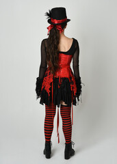 full length portrait burlesque circus performer, female model in halloween jester clown costume...