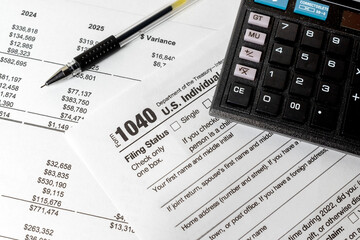 Close-up of US Individual Income Tax Return Form 1040 with a pen and calculator. Represents tax filing, income reporting, financial calculation, and personal or business accounting during tax season.