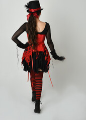 full length portrait burlesque circus performer, female model in halloween jester clown costume...