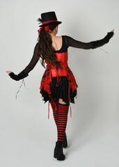 full length portrait burlesque circus performer, female model in halloween jester clown costume...