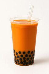 A refreshing glass of orange bubble tea with tapioca pearls and a straw, isolated on white background