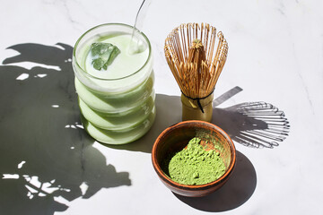 Iced Matcha Refreshment. Refreshing iced matcha drinks with a bamboo whisk and matcha powder