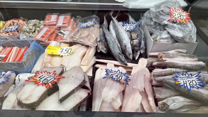 Display of various frozen fish and seafood at local market in Daugavpils, Latvia on July 6, 2025....