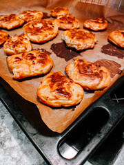 Freshly baked pastries cooling on a tray in a kitchen setting