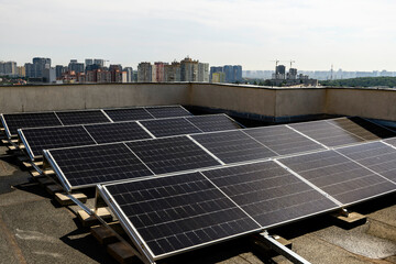 Solar panels installed on the rooftop of a residential building, with a skyline of modern...
