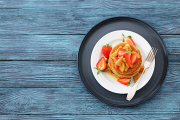 pancakes topped with apple slices and strawberries
