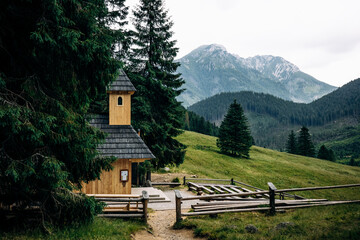 A small church on a summer day, surrounded by forest in the Tatra Mountains