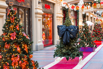 Stylish black bow on the Christmas tree. Beautiful Christmas background. Concept of preparing decorations and furnishings for the New Year. New Year's card 2026.
