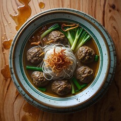 Indonesian bakso noodle soup in soup plate, top view