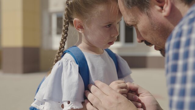 close-up face of little upset child, divorce single father family, student daughter problem with school backpack, disappointment stress kid emotion, child education time, paren psychology of sadness.