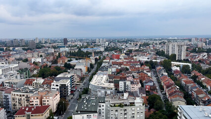 A large European city with ancient streets and roofs made of red tiles. Top view.