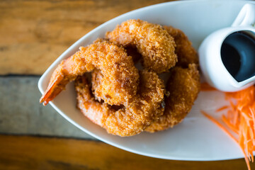 A plate of delicious deep fried shrimps with sweet sweet sauce