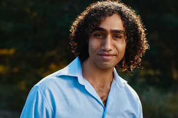 Portrait of a Smiling Individual Outdoors Wearing a Blue Shirt