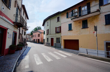Charming European Village Street with Traditional Houses and Bright Blue Sky