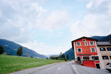 Scenic Village Landscape with Colorful Building and Mountain Backdrop on a Sunny Day