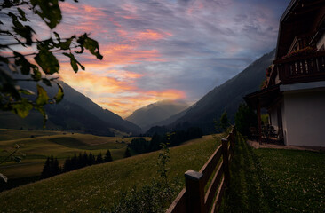 Tranquil Mountain Landscape with Cottage at Sunset in Idyllic Countryside
