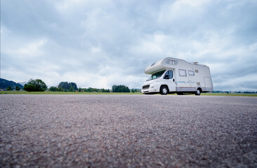 Modern Camper Van Parked in Scenic Countryside Landscape Under Blue Skies