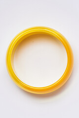 Yellow Circular Bangle Bracelet on a White Background Display