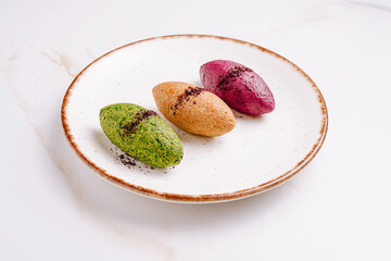Colorful dessert trio featuring matcha, blueberry, and sweet potato flavors